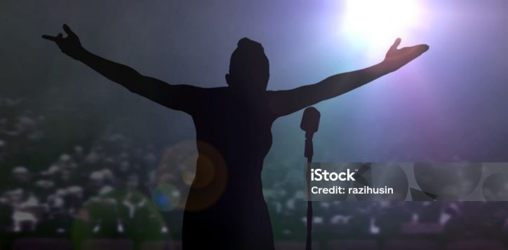 women-bowing-on-stage-after-a-concert-under-bright-spotlights-2